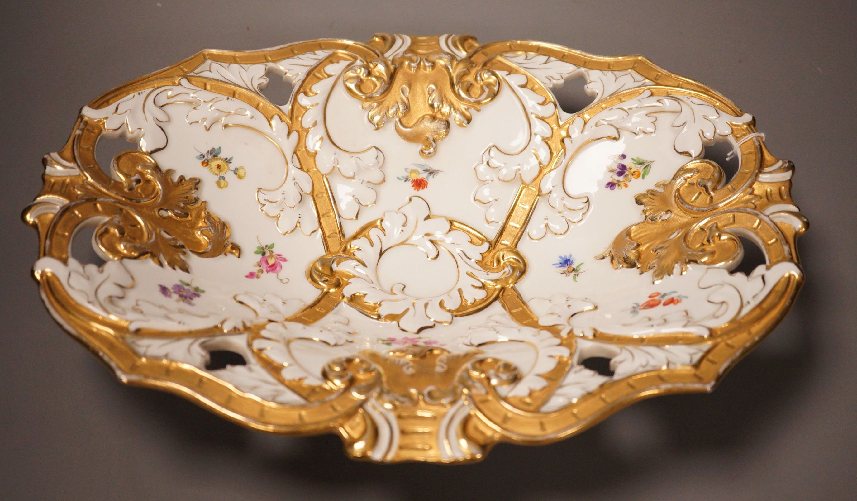 An early 20th century Meissen two handled white and gilt floral oval dish, 32cm